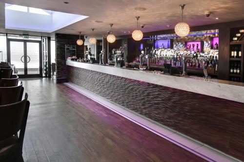 a bar with a long counter with a lot of drinks at Best Western Hotel Hatfield in Lowestoft