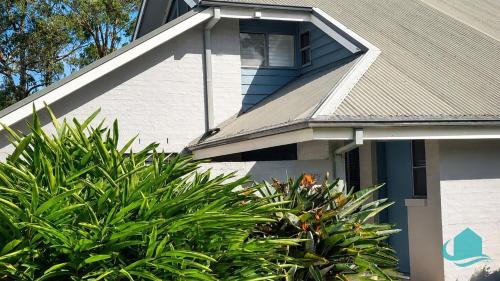 a house with a window on the side of it at Plover Executive Deluxe Villa 25 in Cams Wharf