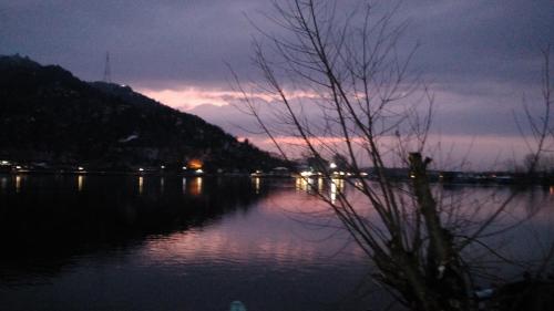 a view of a lake at night at Goona palace houseboats in Srinagar
