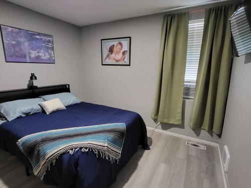 a bedroom with a bed and a window at Grove Street Couplet #2 in Baker City
