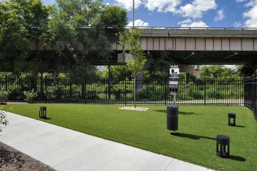 a street sign in the grass next to a bridge at Hyatt House Columbus OSU Short North in Columbus