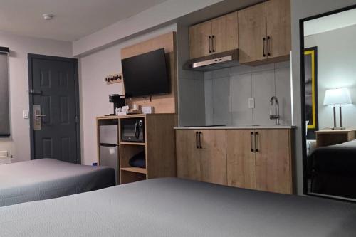 a room with a bedroom with a bed and a tv at Super 8 by Wyndham Clearwater BC in Clearwater
