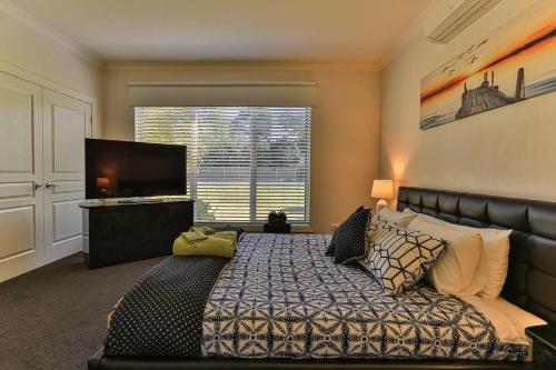 a bedroom with a bed and a large window at Phillip Island Dream Getaway in Ventnor