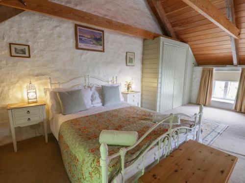 a bedroom with a bed and a wooden ceiling at Sycamore Vestry in Fishguard