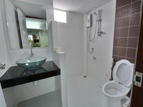 a bathroom with a sink and a toilet at The Bless Residence in Hat Yai