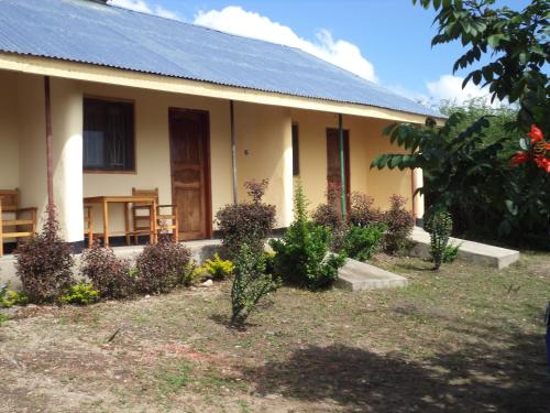 a house with plants in front of it at The Elephant Home in Katunguru