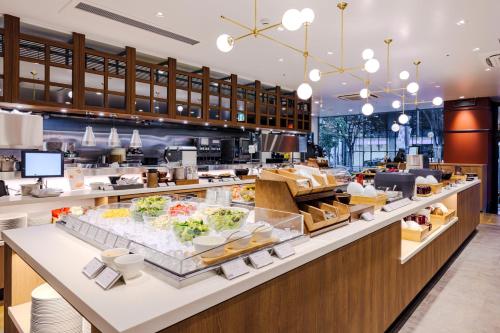 a restaurant with a buffet line with food at Richmond Hotel Nagoya Nayabashi in Nagoya