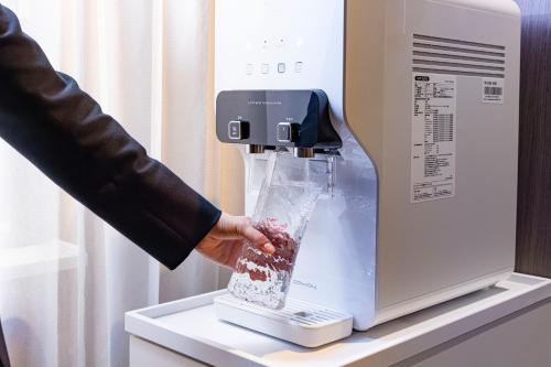 a person is pouring food into a blender at Richmond Hotel Nagoya Nayabashi in Nagoya