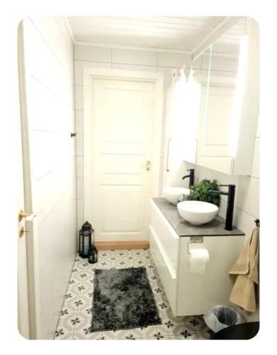 a white bathroom with a sink and a toilet at Casa Peaceful in Mysen