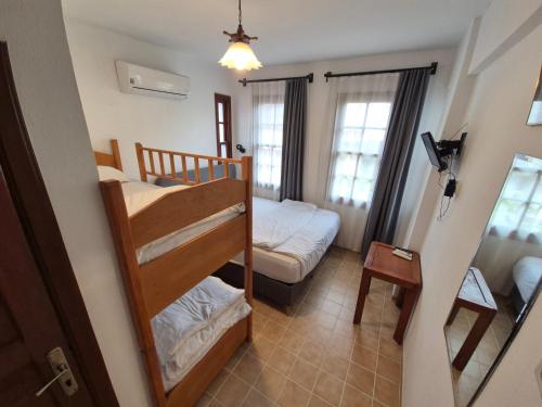 a small room with a bunk bed and a bedroom at Sabah Pansiyon in Antalya