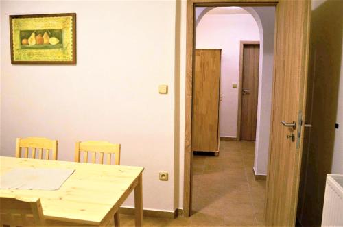 a dining room with a table and chairs and a hallway at EDER- Penzion & Apartmány in Horní Planá