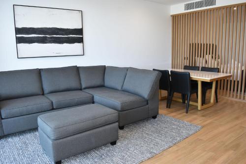 a living room with a couch and a table at Kove Apartment - G05 in Kiama