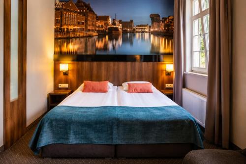 a bedroom with a bed with a view of a river at Apart Neptun in Gdańsk