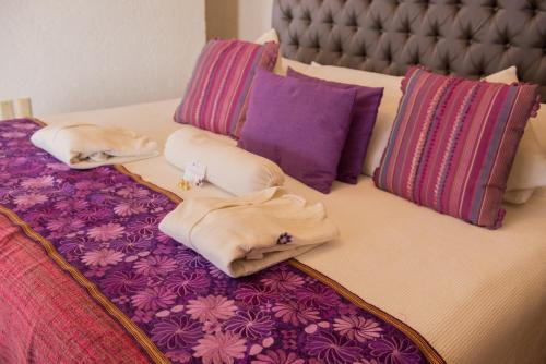 Una cama o camas en una habitación de Hotel Boutique Casa Isabella