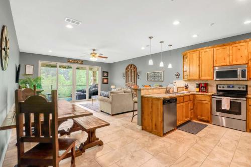 a kitchen and living room with a table and a couch at Cliffside Paradise Waterfront in New Braunfels