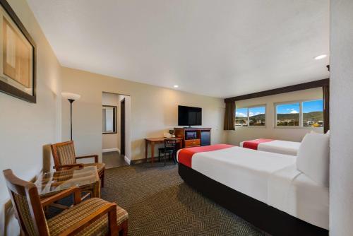 a hotel room with a bed and a desk at Rodeway Inn South San Francisco Airport in South San Francisco