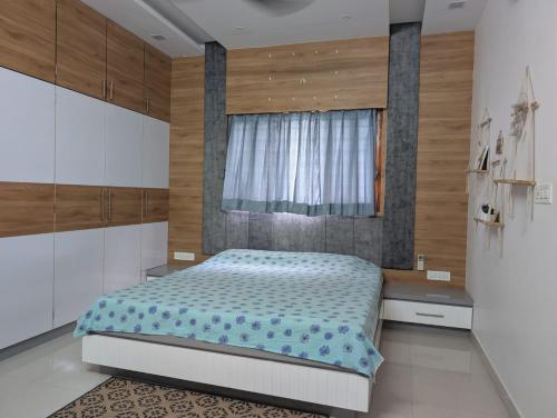 a bedroom with a large bed and a window at Karmawas House in Jodhpur