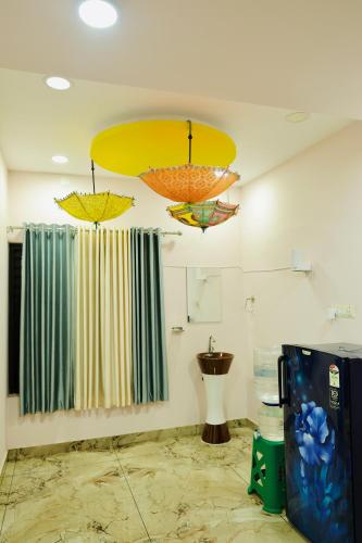 a room with two umbrellas hanging from the ceiling at Varkala Escape Resort in Varkala