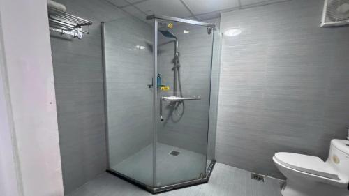 a shower stall in a bathroom with a toilet at Catba Central Hotel 2 in Cat Ba