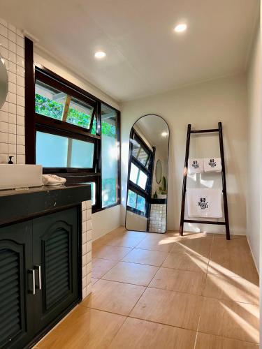 a bathroom with a sink and a mirror in a room at Bearwolf Koh Kood in Ko Kood