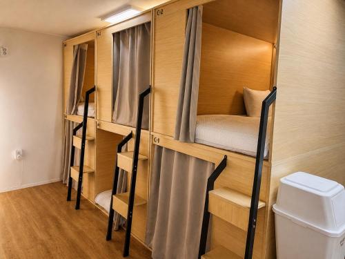 a room with two bunk beds and a toilet at Moonraejung Hostel in Seoul