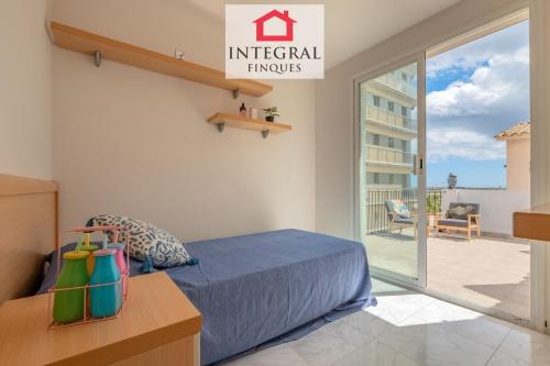 a bedroom with a bed and a balcony at Casa Aiguamarina in Palamós
