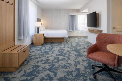 a hotel room with a bed and a desk and a chair at Hampton Inn & Suites Redding in Redding