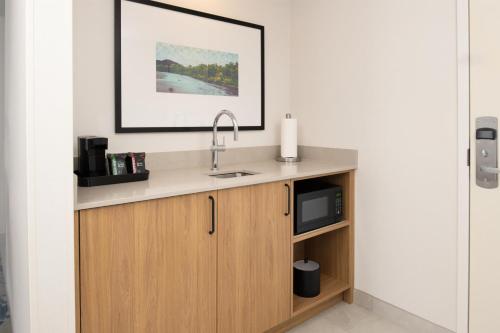 a kitchen with a sink and a microwave at Hampton Inn & Suites Redding in Redding