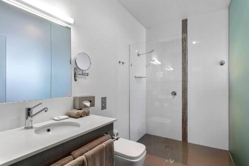 a bathroom with a sink and a toilet and a shower at Quality Inn The George Hotel Ballarat in Ballarat