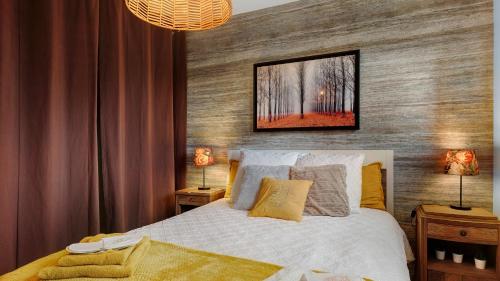 a bedroom with a bed with two night stands and two lamps at Chambre calme avec petit déjeuner in Gévezé