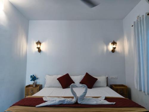 a bedroom with a bed with a ribbon on it at Shampagne Villa in Cochin