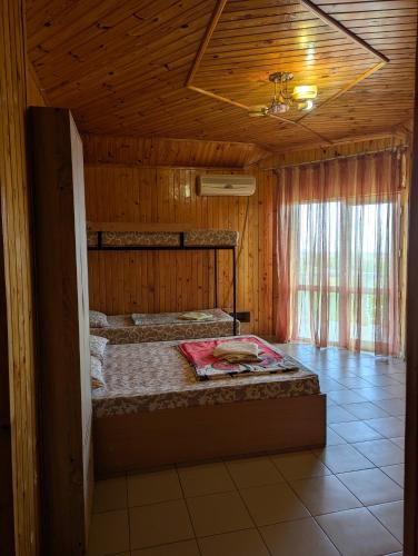 a bedroom with two bunk beds in a wooden room at Бирюза in Karolino-Buhaz
