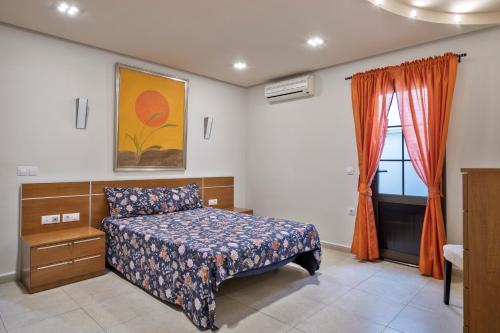 a bedroom with a bed and a window at Casa Emma in Playa Honda