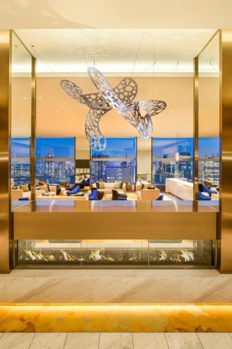 a lobby of a hotel with chairs and a chandelier at The Prince Gallery Tokyo Kioicho, a Luxury Collection Hotel in Tokyo