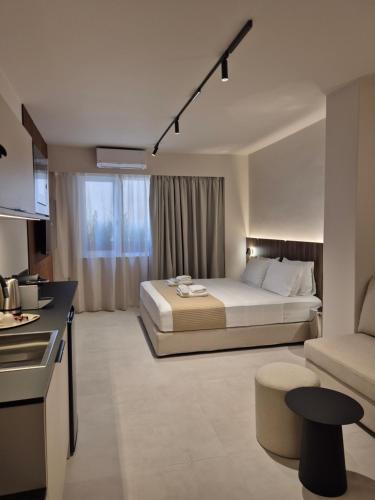 a hotel room with a bed and a kitchen at Shape Suites Athens in Athens