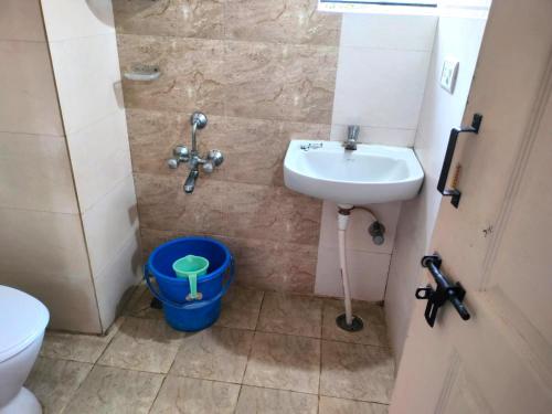 a small bathroom with a sink and a toilet at Hotel Amulya Relax Inn in Bangalore