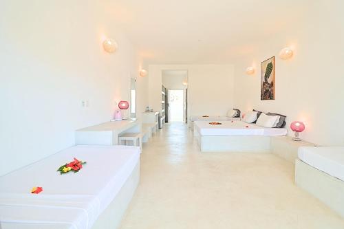 a white living room with two white couches at Ascot Watamu Resort in Watamu