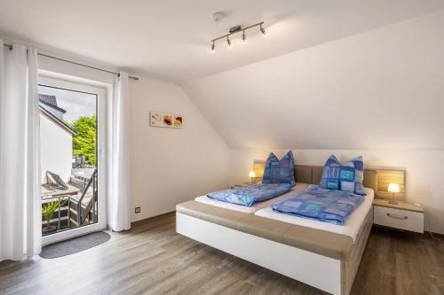 a bedroom with a bed and a balcony at Ferienwohnung Niemeier in Brilon