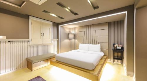 a bedroom with a white bed in a room at 747 Motel in Gimcheon