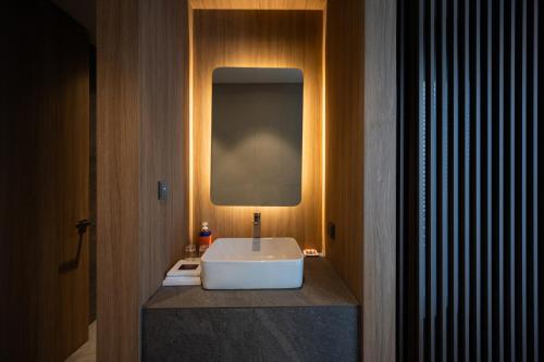 a bathroom with a white sink on a counter at Hotel Editions Mokpo in Mokpo