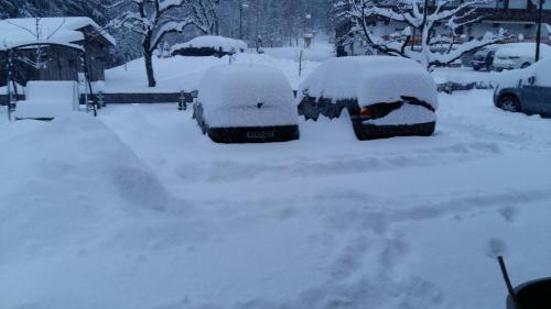 a snow covered parking lot with cars covered in snow at Haus Binder in Ried im Zillertal