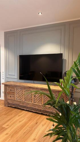 a large flat screen tv in a living room at AMAO-Ivory - Business Apartment - 6 Guests - Parking in Offenburg