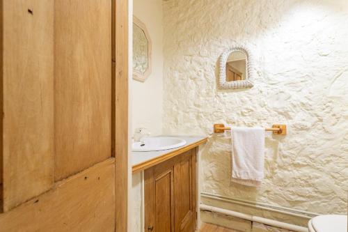 a white bathroom with a sink and a shower at Appartement 1 in Sauzet