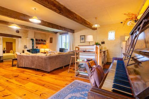 a living room with a couch and a table at Appartement 2 in Sauzet