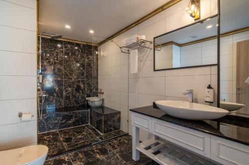 a bathroom with a sink and a shower at Ween Otel in Trabzon