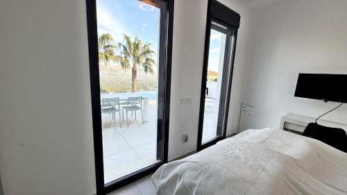 a bedroom with a bed and a view of a patio at Villa Titulabo in Orba