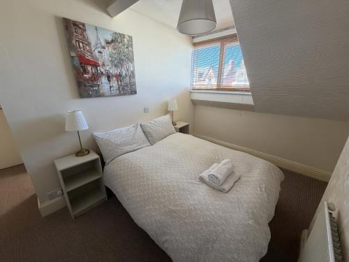 a small bedroom with a bed with a towel on it at Avalon Lodge in Bridlington