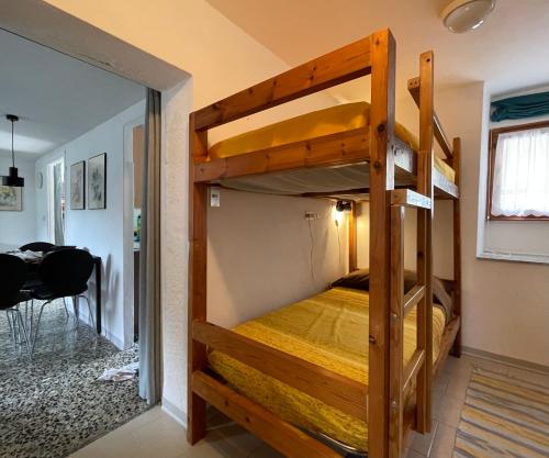 a bunk bed in a room with a doorway at Maison à la coque in Baceno