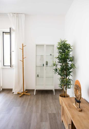 a room with a white cabinet and a potted plant at Villa Valentina in Taranto
