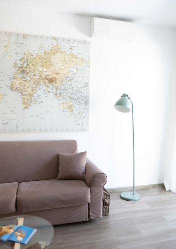 a living room with a couch and a map on the wall at Villa Valentina in Taranto